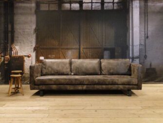 grijze geschuurd leren bank